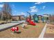Community playground with slides, playground equipment, swings, and soft landing on a beautiful day at 1950 W 67Th Ave, Denver, CO 80221