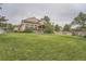 Expansive backyard with lush lawn and views of the home's exterior at 11522 Pine Grove Ln, Parker, CO 80138