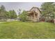Grassy backyard showcases the patio, landscaping, and exterior of the home at 11522 Pine Grove Ln, Parker, CO 80138