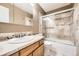 Bathroom showcasing a tiled shower, wood vanity, and stone countertop at 11522 Pine Grove Ln, Parker, CO 80138