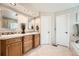 Bright bathroom featuring a double vanity, tiled floor, and recessed lighting at 11522 Pine Grove Ln, Parker, CO 80138