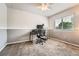 Simple bedroom with ceiling fan and large window, perfect for study at 11522 Pine Grove Ln, Parker, CO 80138