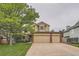 Charming two-story home with a large tree and a spacious three-car garage at 11522 Pine Grove Ln, Parker, CO 80138