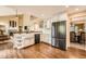 Open kitchen with stainless steel appliances, white cabinets, and a farmhouse sink at 11522 Pine Grove Ln, Parker, CO 80138