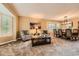 Cozy living room with large windows, neutral carpet, and open to the dining area at 11522 Pine Grove Ln, Parker, CO 80138
