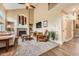 Bright living room featuring a brick fireplace, high ceilings, and a ceiling fan at 11522 Pine Grove Ln, Parker, CO 80138
