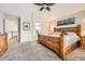Spacious main bedroom featuring a ceiling fan, large bed, and connecting bathroom at 11522 Pine Grove Ln, Parker, CO 80138