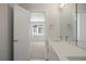 Contemporary bathroom with double sinks, quartz countertops and a view to the bedroom at 4024 Upham St, Wheat Ridge, CO 80033