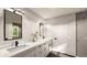 Modern bathroom featuring double vanity, white cabinets, and sleek black fixtures at 4024 Upham St, Wheat Ridge, CO 80033