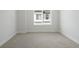 Empty bedroom featuring neutral carpet, white walls, and a bright window at 4024 Upham St, Wheat Ridge, CO 80033