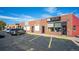 Commercial exterior view showcasing a red brick building with multiple businesses and street parking at 4024 Upham St, Wheat Ridge, CO 80033