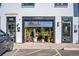 Trendy storefront with open garage door design, showcasing plants and unique interior at 4024 Upham St, Wheat Ridge, CO 80033