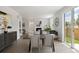 Open-concept dining area with modern furniture, leading into the living room and outdoor patio at 4024 Upham St, Wheat Ridge, CO 80033