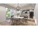 Dining area open to kitchen with marble table and sliding glass doors to backyard at 4024 Upham St, Wheat Ridge, CO 80033