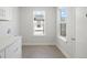 Bright laundry room with white cabinets, ample counter space, and windows for natural light at 4024 Upham St, Wheat Ridge, CO 80033