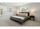 A large, naturally lit main bedroom with contemporary decor and plush carpeting at 4024 Upham St, Wheat Ridge, CO 80033