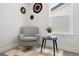 Cozy sitting area featuring comfortable armchair, a side table, and decorative wall art at 4024 Upham St, Wheat Ridge, CO 80033