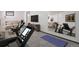 Bright basement area with an exercise bike, treadmill and a comfortable sitting area at 7391 Dale Ct, Westminster, CO 80030