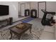 Spacious basement area featuring a treadmill, weights, and a cozy sofa at 7391 Dale Ct, Westminster, CO 80030