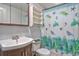 Bright bathroom with a charming sea turtle-themed shower curtain and sleek vanity at 7391 Dale Ct, Westminster, CO 80030