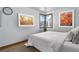 This bedroom features an art wall and a cozy corner window at 7391 Dale Ct, Westminster, CO 80030