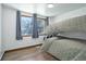 This cozy bedroom features a bunk bed, hardwood floors and a well-lit window at 7391 Dale Ct, Westminster, CO 80030