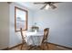 Cozy dining area features wood floors, a table for three, and a bright window for natural light at 7391 Dale Ct, Westminster, CO 80030