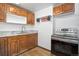 Classic kitchen with wood cabinets, light countertops, stainless steel appliances, and hardwood floors at 7391 Dale Ct, Westminster, CO 80030