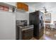 Modern kitchen features stainless steel appliances, wood cabinets, and an inviting dining area at 7391 Dale Ct, Westminster, CO 80030