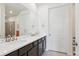 Double vanity bathroom with a large mirror and shower at 7766 Fraser River Cir, Littleton, CO 80125