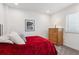 Spacious bedroom with red bedding and a wooden dresser at 7766 Fraser River Cir, Littleton, CO 80125