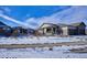 Two-story house with snow-covered yard and neighborhood view at 7766 Fraser River Cir, Littleton, CO 80125