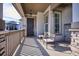 Inviting front porch with seating area and view of the neighborhood at 7766 Fraser River Cir, Littleton, CO 80125