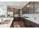 Modern kitchen with stainless steel appliances and dark brown cabinets at 7766 Fraser River Cir, Littleton, CO 80125