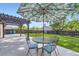 Backyard patio with outdoor seating under a decorative umbrella, perfect for relaxation and entertaining at 11617 W 71St Dr, Arvada, CO 80004
