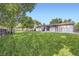Large backyard featuring a well-maintained lawn, patio area with pergola, and a spacious outdoor area at 11617 W 71St Dr, Arvada, CO 80004