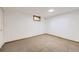 Finished basement area features neutral walls and carpet, a small window, and ample space at 11617 W 71St Dr, Arvada, CO 80004