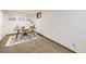 Finished basement area featuring an office setup with neutral decor and cozy carpet at 11617 W 71St Dr, Arvada, CO 80004