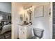 Charming half-bath near bedroom featuring modern fixtures and vanity with decorative mirror at 11617 W 71St Dr, Arvada, CO 80004