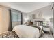 Cozy bedroom featuring a large window, neutral tones, stylish decor and soft carpet at 11617 W 71St Dr, Arvada, CO 80004