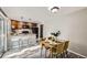 An open dining and kitchen area offering a breakfast bar, dining table, and ample natural light at 11617 W 71St Dr, Arvada, CO 80004