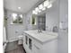 Bright bathroom featuring a white vanity with modern lighting, complemented by a window view and tiled floors at 29304 Thimbleberry Ln, Evergreen, CO 80439