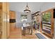 Charming dining room with wood floors, stylish lighting, and a view of the outdoors at 29304 Thimbleberry Ln, Evergreen, CO 80439