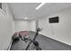 Workout room featuring a stationary bike, yoga mat, and a mounted TV at 29304 Thimbleberry Ln, Evergreen, CO 80439