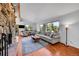 Bright living room featuring hardwood floors, large windows with mountain views, and stylish decor at 29304 Thimbleberry Ln, Evergreen, CO 80439