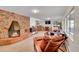 Cozy living room with brick fireplace and an array of seating options at 29304 Thimbleberry Ln, Evergreen, CO 80439