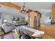 Open-concept living and dining area featuring hardwood floors, stone accent wall, and modern furnishings at 29304 Thimbleberry Ln, Evergreen, CO 80439