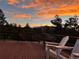 Breathtaking sunset views can be seen from the outdoor seating area at 29304 Thimbleberry Ln, Evergreen, CO 80439