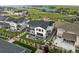 Aerial view of a home with a spacious backyard, outdoor seating, and lush landscaping near a lake at 6737 S White Crow Way, Aurora, CO 80016