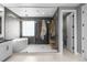 Bright bathroom with a large soaking tub, glass shower, and a view of the toilet and vanity area at 6737 S White Crow Way, Aurora, CO 80016